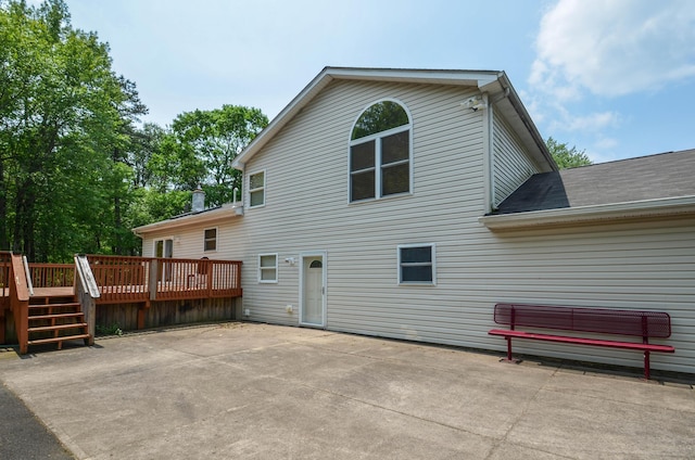1214 Shadblow Rd, Pocono Summit, PA 18346 - rear view of property featuring a deck, a patio, and roof with shingles