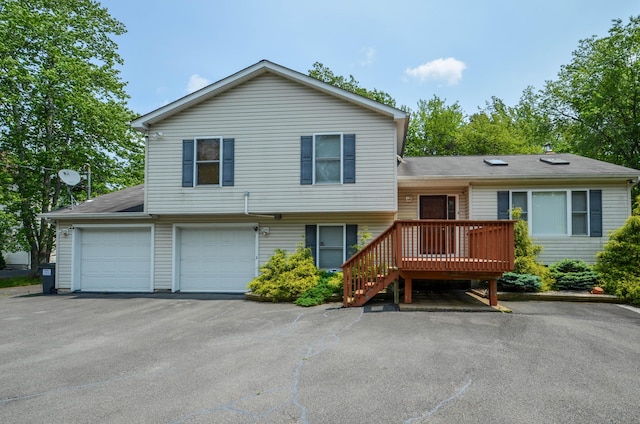1214 Shadblow Rd, Pocono Summit, PA 18346 - tri-level home with a wooden deck, asphalt driveway, a shingled roof, and a garage
