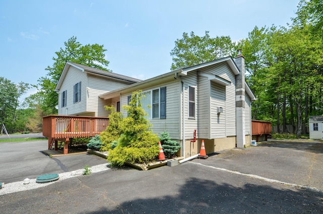 1214 Shadblow Rd, Pocono Summit, PA 18346 - view of home's exterior featuring a deck and a chimney