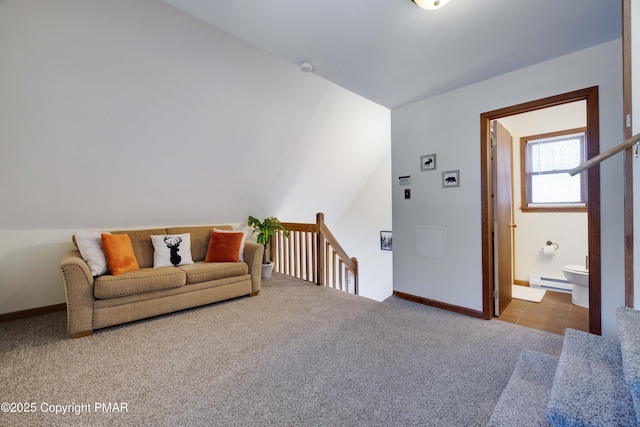 interior space with lofted ceiling, a baseboard radiator, and baseboards