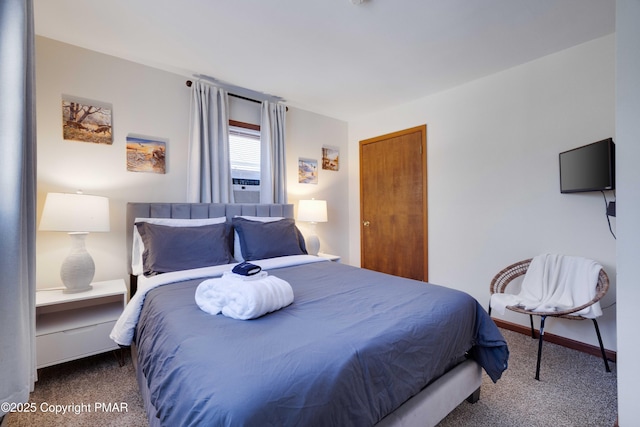 bedroom featuring carpet and baseboards