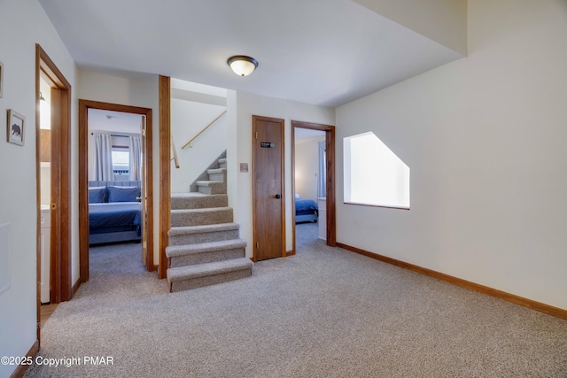 stairs with carpet flooring and baseboards