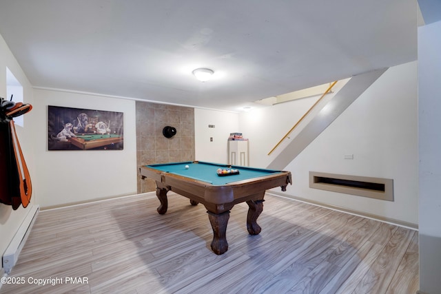 rec room with pool table, a baseboard radiator, and light wood-style floors