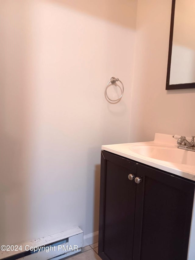 bathroom featuring tile patterned flooring, vanity, and baseboards