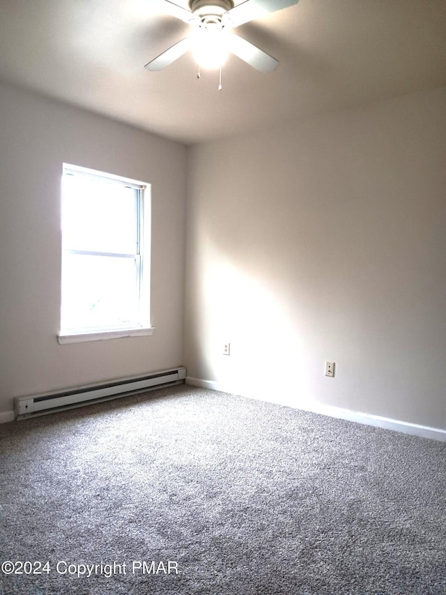 empty room with carpet floors, baseboard heating, and a ceiling fan