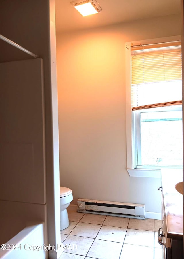 full bath with a baseboard heating unit, tile patterned flooring, vanity, and toilet