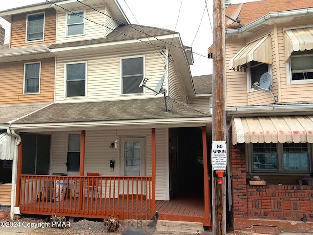 view of front of property with a porch and roof with shingles