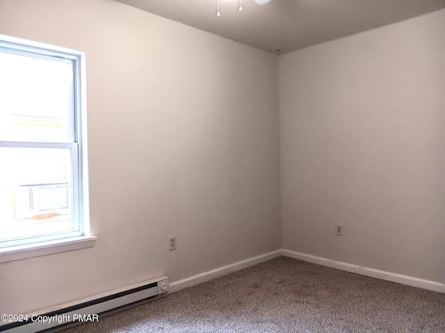 carpeted empty room featuring baseboards and a baseboard heating unit