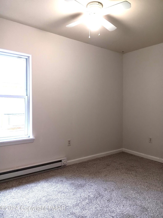 carpeted empty room featuring a baseboard radiator, baseboards, and ceiling fan