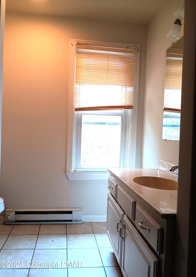 bathroom featuring a baseboard radiator, tile patterned flooring, vanity, and baseboards