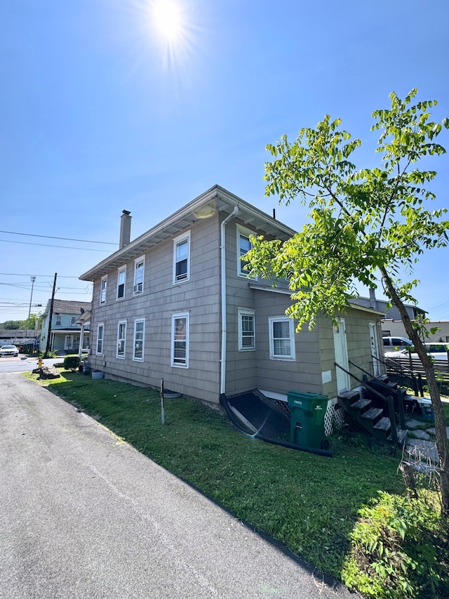 373-375 N Courtland St, East Stroudsburg, PA 18301 - view of side of home with a lawn and a chimney