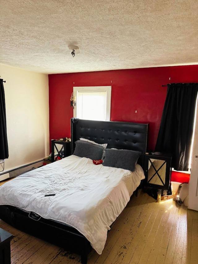 373-375 N Courtland St, East Stroudsburg, PA 18301 - bedroom with a textured ceiling, hardwood / wood-style floors, and a baseboard radiator