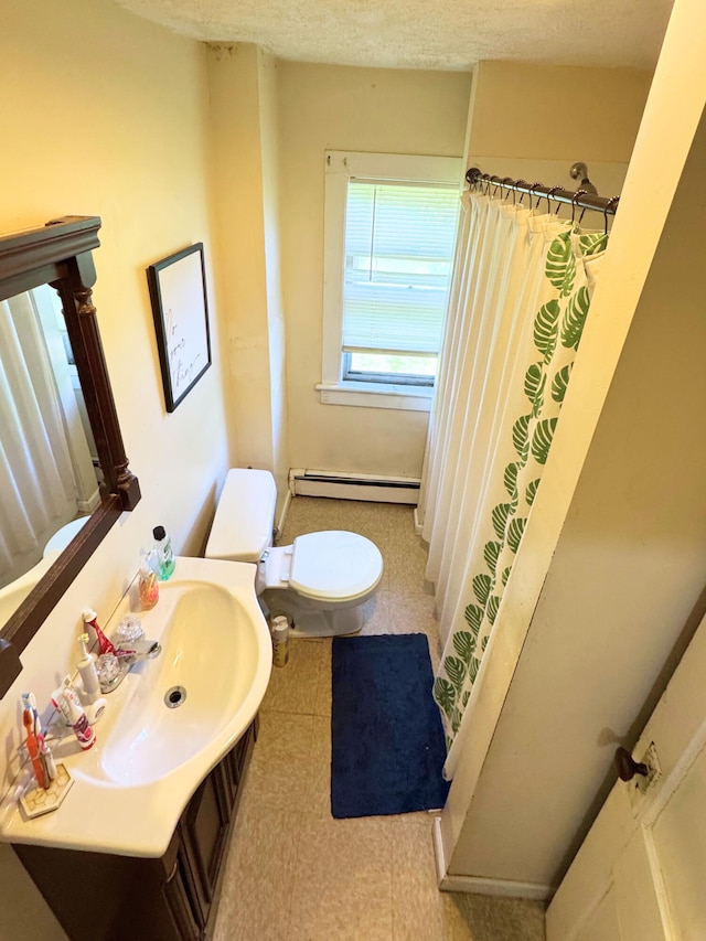 373-375 N Courtland St, East Stroudsburg, PA 18301 - bathroom with a baseboard radiator, toilet, vanity, and curtained shower