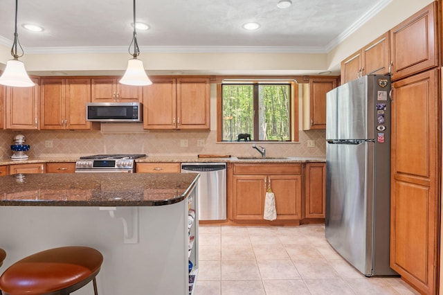 450 Bear Creek Lake Dr, Jim Thorpe, PA 18229 - kitchen featuring appliances with stainless steel finishes, crown molding, tasteful backsplash, dark stone countertops, and a breakfast bar area