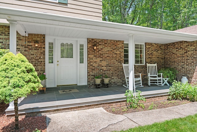 450 Bear Creek Lake Dr, Jim Thorpe, PA 18229 - doorway to property featuring covered porch and brick siding