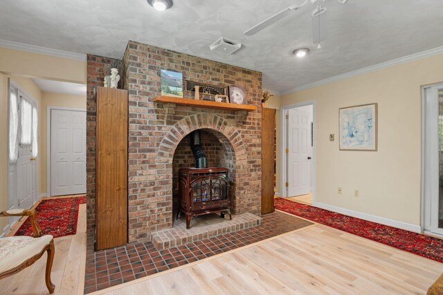450 Bear Creek Lake Dr, Jim Thorpe, PA 18229 - living room with wood finished floors, a wood stove, crown molding, and a ceiling fan