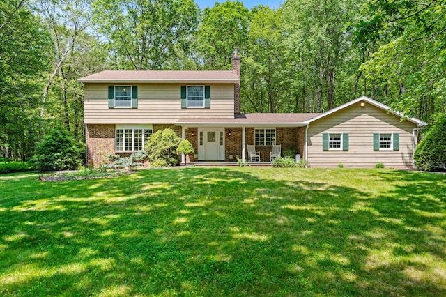 450 Bear Creek Lake Dr, Jim Thorpe, PA 18229 - view of front of property with a chimney, brick siding, and a front yard