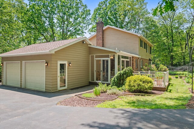 450 Bear Creek Lake Dr, Jim Thorpe, PA 18229 - view of front of property featuring a garage, a chimney, brick siding, and asphalt driveway