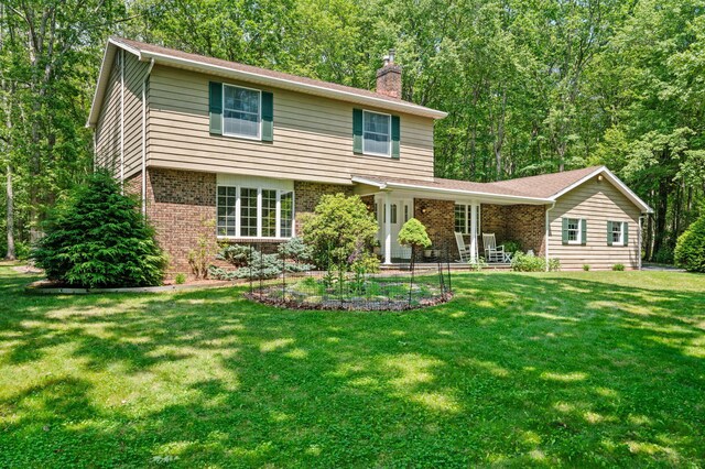 450 Bear Creek Lake Dr, Jim Thorpe, PA 18229 - back of house featuring brick siding, a chimney, and a yard