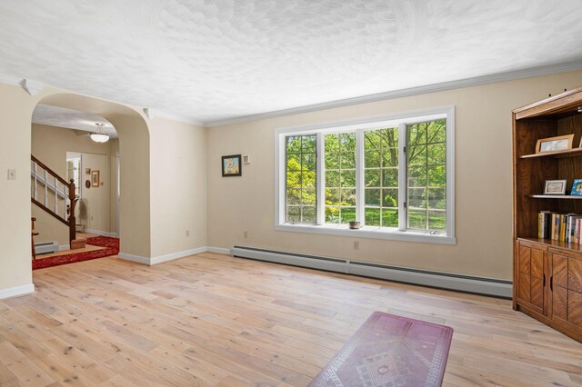 450 Bear Creek Lake Dr, Jim Thorpe, PA 18229 - unfurnished room with baseboard heating, stairway, arched walkways, light wood-style floors, and ornamental molding