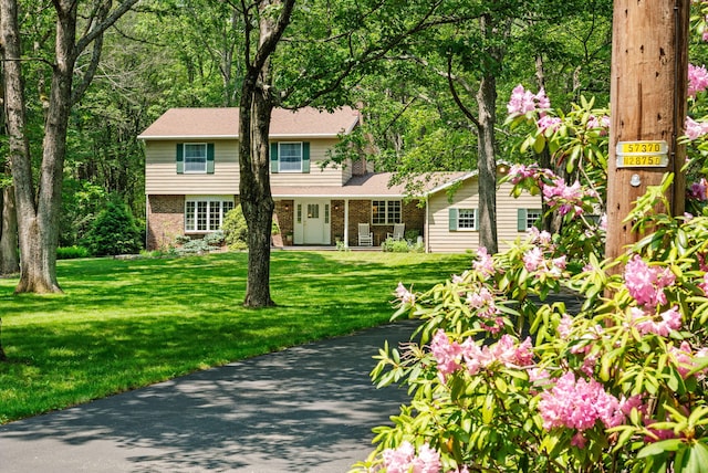 450 Bear Creek Lake Dr, Jim Thorpe, PA 18229 - view of front of house featuring brick siding, a front yard, and covered porch