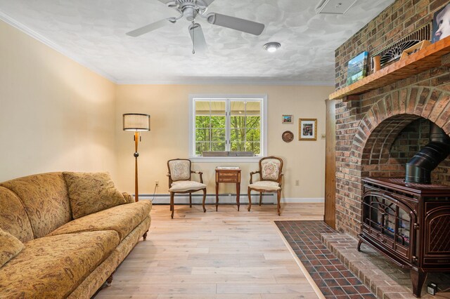 450 Bear Creek Lake Dr, Jim Thorpe, PA 18229 - living room with a wood stove, baseboard heating, ceiling fan, wood finished floors, and crown molding