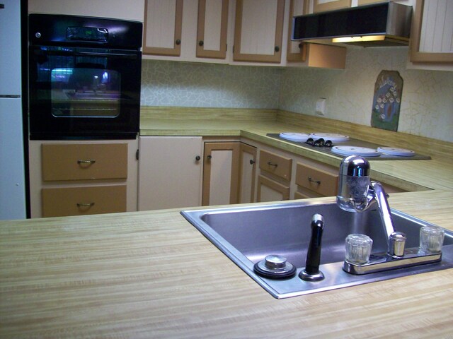 2112 Yorkshire Ct, Bushkill, PA 18324 - kitchen featuring oven, wall chimney exhaust hood, tasteful backsplash, electric stovetop, and wood counters