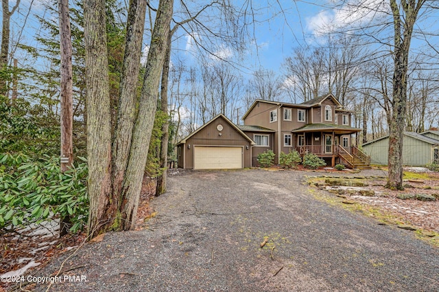 view of front of home with covered porch and a garage