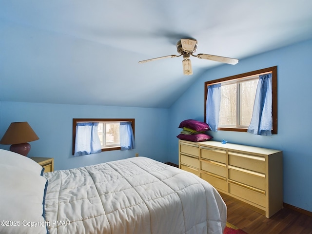 bedroom featuring lofted ceiling, baseboards, a ceiling fan, and dark wood-type flooring