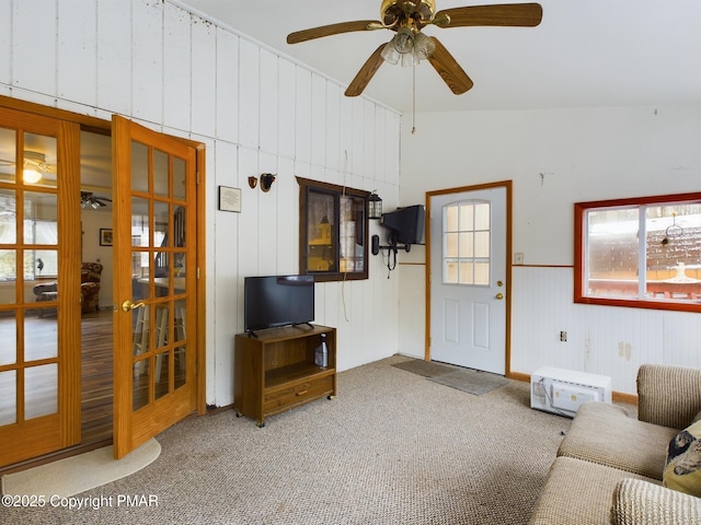 carpeted living room featuring ceiling fan and french doors