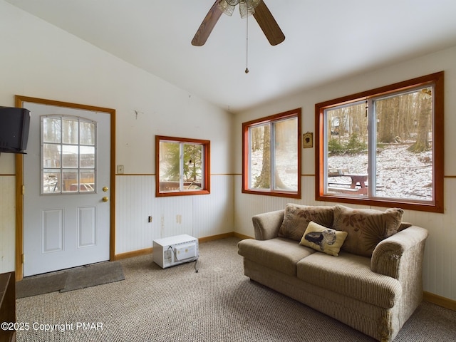 carpeted living area featuring vaulted ceiling and ceiling fan