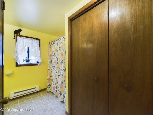 bathroom with baseboards and a baseboard heating unit