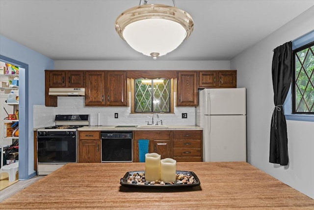 130 Deer Trail Dr, Saylorsburg, PA 18353 - kitchen featuring freestanding refrigerator, black dishwasher, gas stove, under cabinet range hood, and light countertops