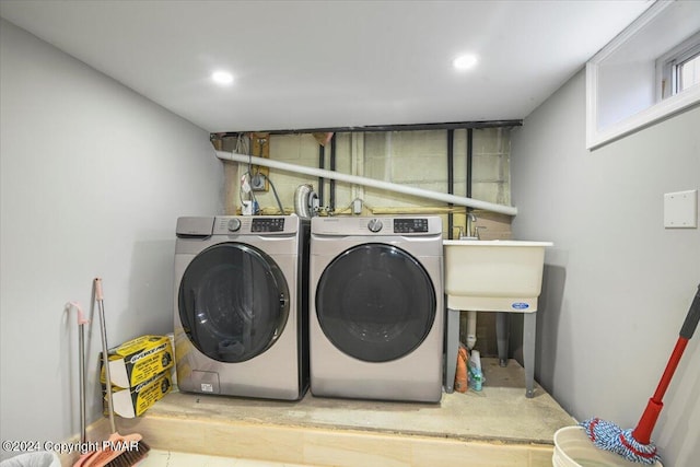 laundry room with a sink, laundry area, washing machine and dryer, and recessed lighting