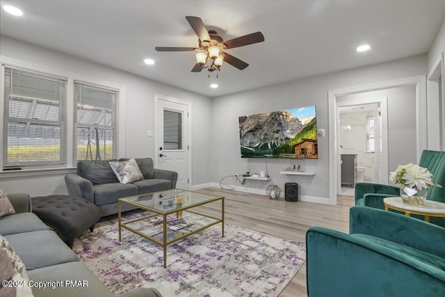 living room featuring ceiling fan, baseboards, wood finished floors, and recessed lighting