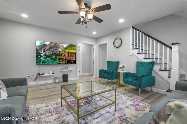 living area featuring recessed lighting, stairway, baseboards, and wood finished floors