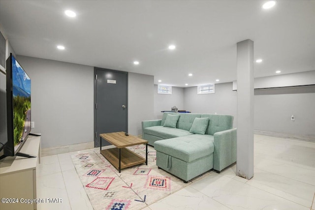 living room featuring baseboards and recessed lighting