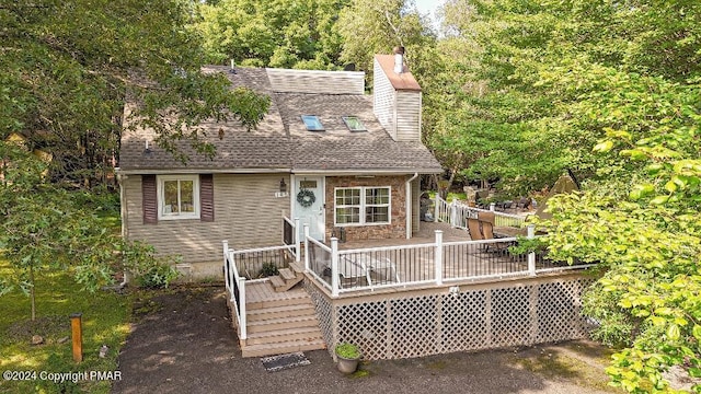 view of front facade featuring crawl space, a shingled roof, and a deck