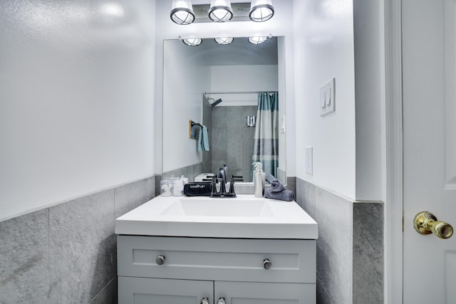 6214 Blackberry Ter, East Stroudsburg, PA 18301 - bathroom with vanity, tile walls, curtained shower, and wainscoting
