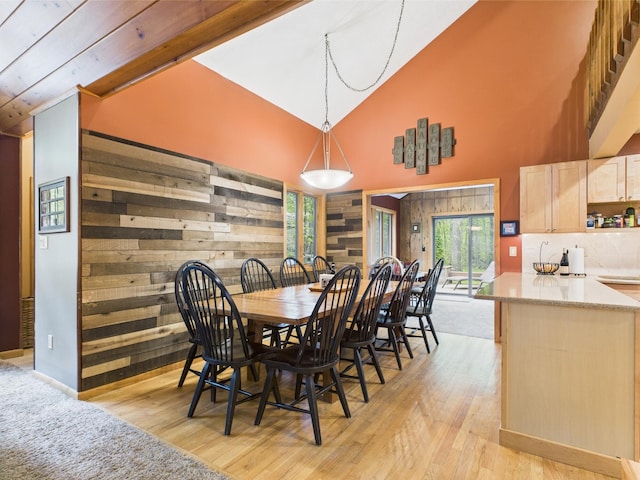 140 Boones Trl, Pocono Pines, PA 18350 - dining area featuring high vaulted ceiling, light wood-type flooring, and wood walls