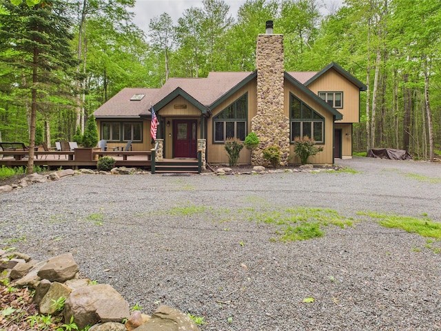 140 Boones Trl, Pocono Pines, PA 18350 - view of front of home with a chimney, a deck, and roof with shingles
