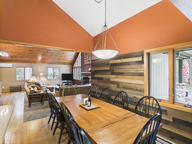 140 Boones Trl, Pocono Pines, PA 18350 - dining space with lofted ceiling, wood-type flooring, an AC wall unit, and a baseboard heating unit