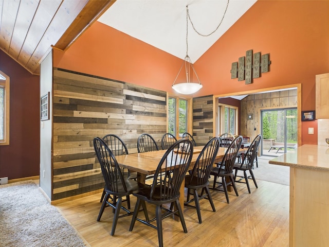 140 Boones Trl, Pocono Pines, PA 18350 - dining space with high vaulted ceiling, light wood-style floors, wooden walls, and baseboards