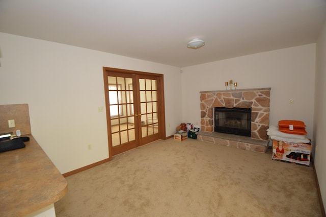 141 Fergus Way, Tobyhanna, PA 18466 - living area featuring french doors, carpet flooring, and a stone fireplace