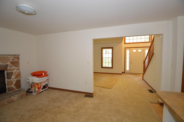 141 Fergus Way, Tobyhanna, PA 18466 - foyer with light colored carpet, a stone fireplace, and stairs