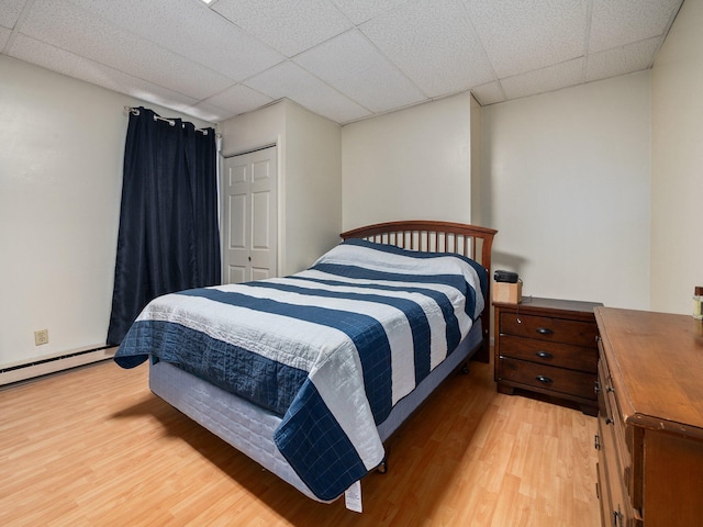 210 N Schanck Ave, Pen Argyl, PA 18072 - bedroom featuring light wood-style floors, a paneled ceiling, a closet, and a baseboard radiator