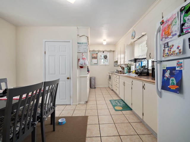 210 N Schanck Ave, Pen Argyl, PA 18072 - kitchen featuring white appliances, light tile patterned floors, white cabinets, and ornamental molding