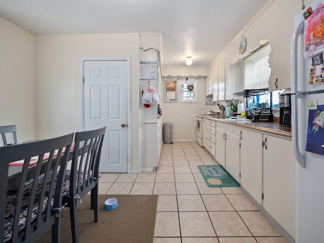 210 N Schanck Ave, Pen Argyl, PA 18072 - kitchen featuring white appliances, light tile patterned flooring, white cabinetry, and crown molding