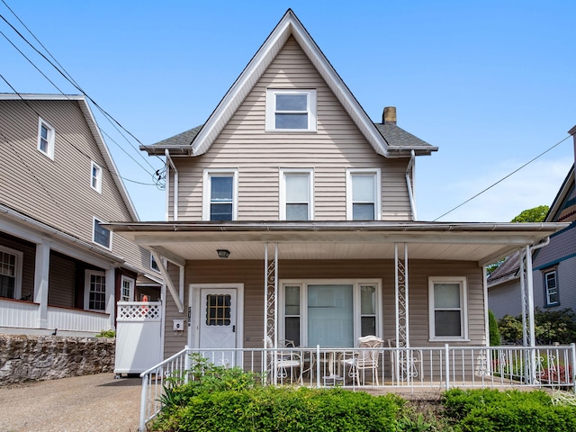 210 N Schanck Ave, Pen Argyl, PA 18072 - view of front facade featuring a porch and a chimney
