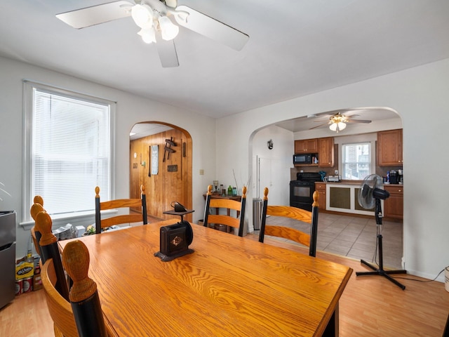 210 N Schanck Ave, Pen Argyl, PA 18072 - dining room with arched walkways, a ceiling fan, and light wood-type flooring